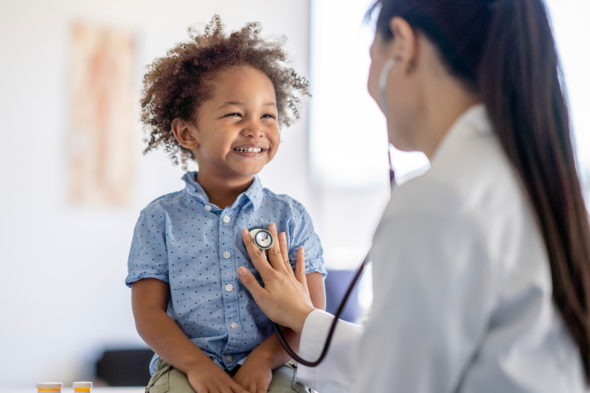 GP doctor consulting child patient in surgery